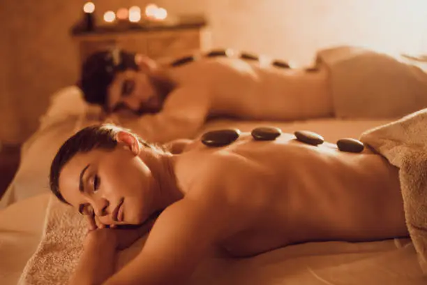 Young couple relaxing at the spa during their Lastone therapy.